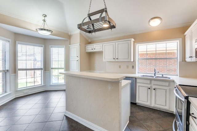 kitchen with stainless steel appliances, white cabinetry, light countertops, and pendant lighting