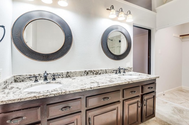 bathroom featuring double vanity, baseboards, and a sink