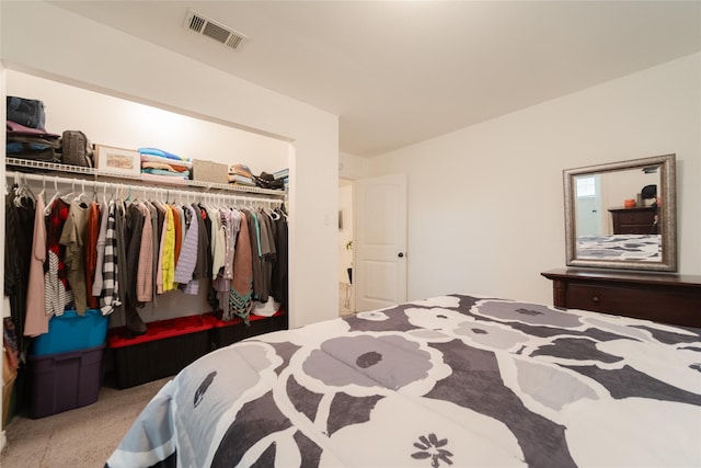 bedroom featuring light carpet and a closet