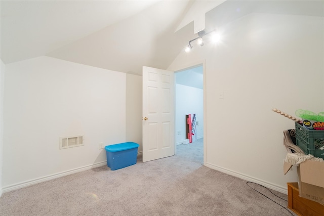 interior space with lofted ceiling and light carpet