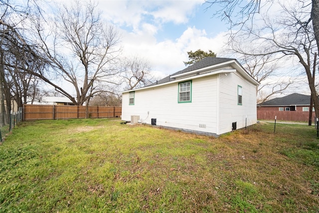 back of house featuring a yard and central AC unit