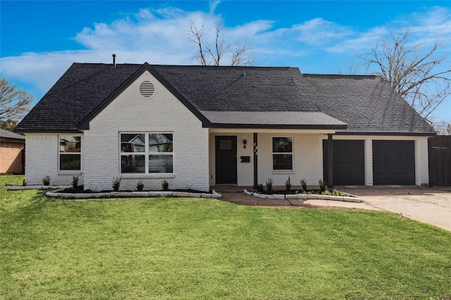 view of front facade featuring an attached garage, driveway, brick siding, and a front yard