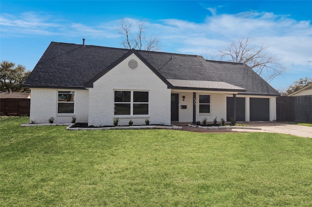 view of front of home with brick siding, a shingled roof, fence, driveway, and a front lawn