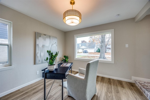 home office with light hardwood / wood-style flooring