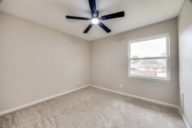 unfurnished room with ceiling fan and carpet flooring