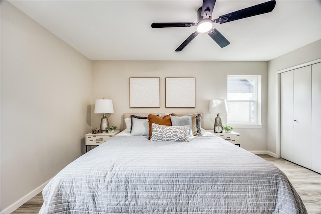 bedroom with a closet, ceiling fan, and light hardwood / wood-style flooring