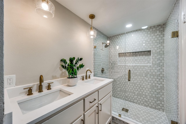 bathroom featuring vanity and a shower with door