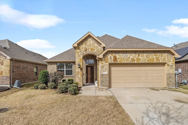 view of front of property with a garage and a front lawn