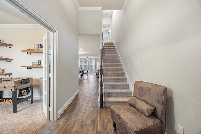 stairs featuring hardwood / wood-style flooring, crown molding, and ceiling fan