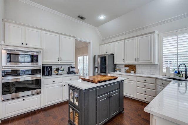 kitchen with stainless steel appliances, white cabinets, and a kitchen island