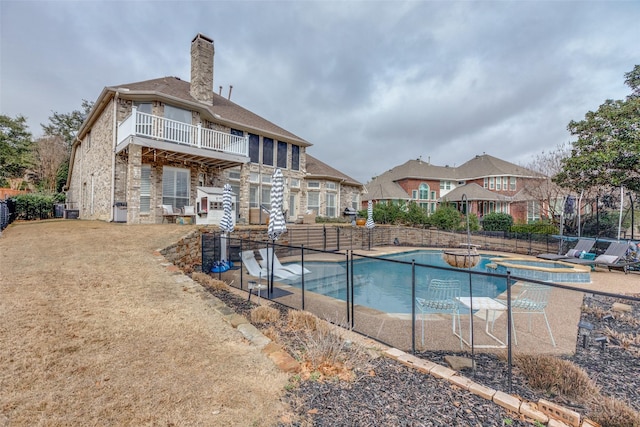 view of swimming pool with an in ground hot tub and a patio area