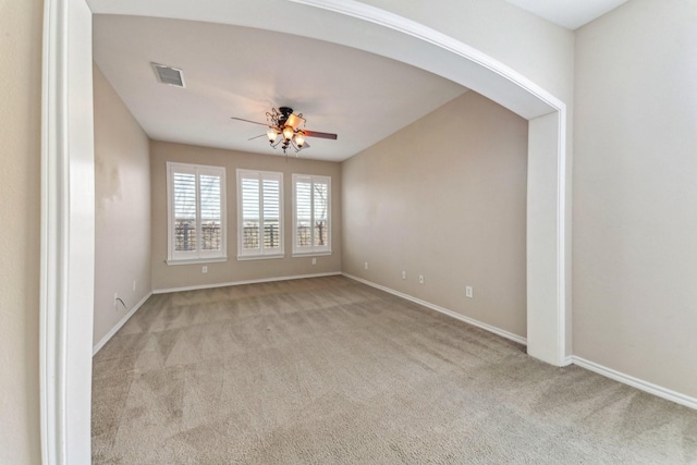 carpeted spare room with ceiling fan