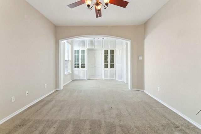 carpeted empty room featuring ceiling fan and lofted ceiling