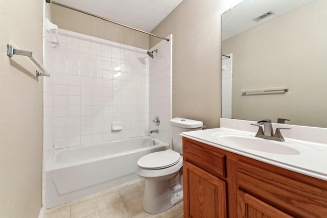 full bathroom with vanity, tiled shower / bath, tile patterned floors, and toilet