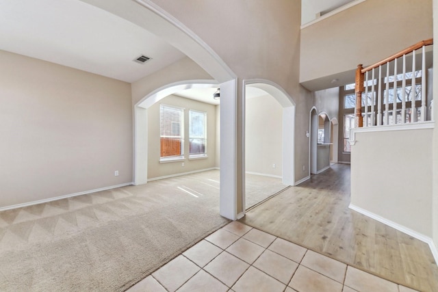 foyer entrance with light colored carpet