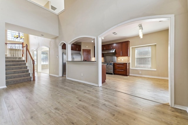 unfurnished living room with plenty of natural light and light hardwood / wood-style flooring