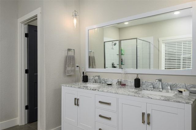 bathroom with vanity and a shower with shower door