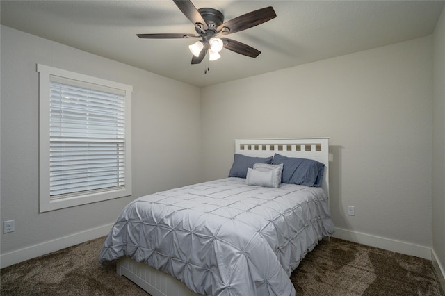 bedroom featuring ceiling fan and dark carpet