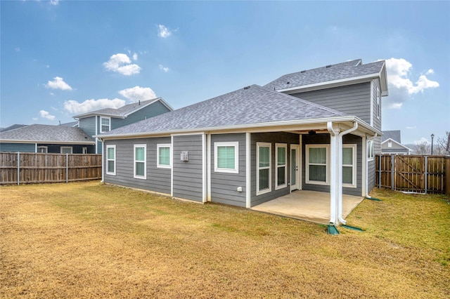 back of house featuring a patio and a yard