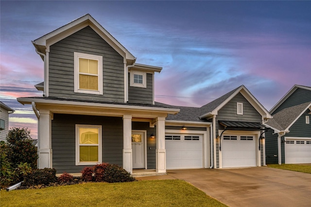 craftsman-style home featuring a porch, a yard, and a garage