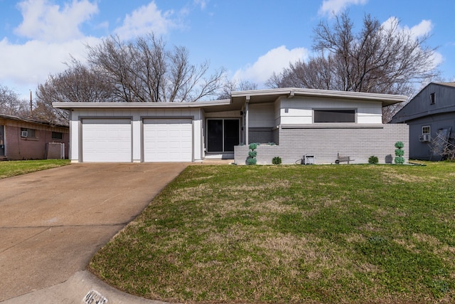 view of front facade with a garage and a front lawn