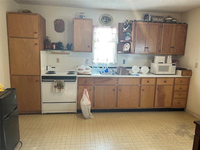 kitchen featuring white appliances and a textured ceiling