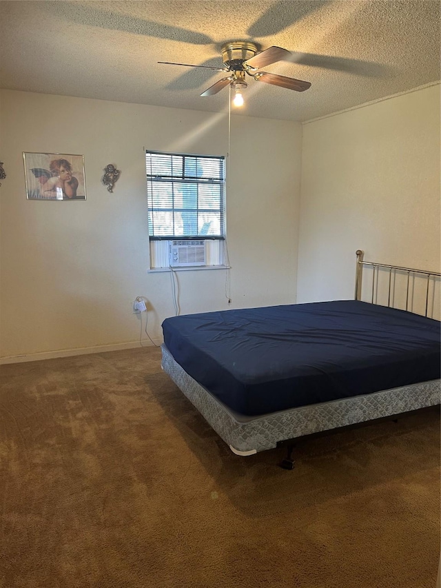 unfurnished bedroom featuring ceiling fan, carpet, and a textured ceiling