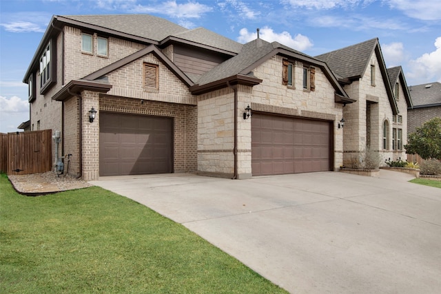 view of front of home featuring a front yard and a garage