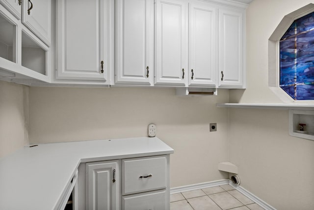 laundry room with cabinets, electric dryer hookup, washer hookup, and light tile patterned floors