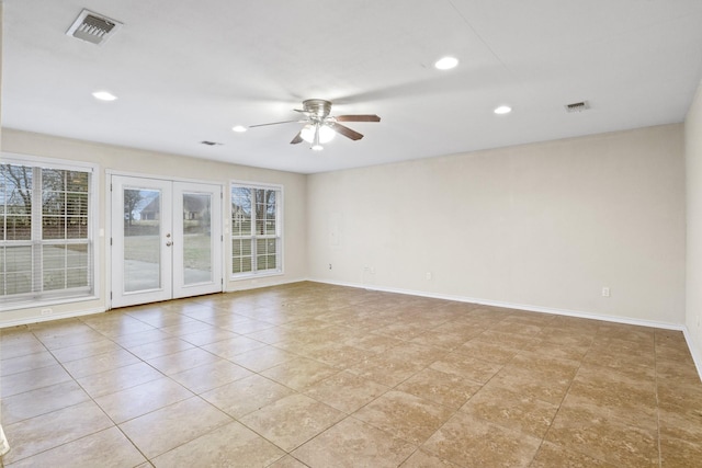 tiled spare room featuring french doors, ceiling fan, and a healthy amount of sunlight