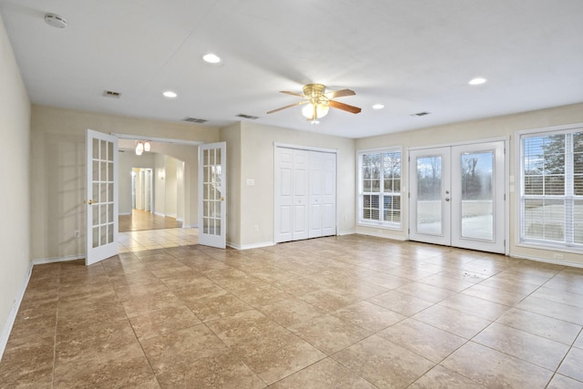 empty room with light tile patterned floors, french doors, and ceiling fan