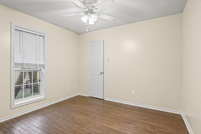 empty room featuring dark hardwood / wood-style floors and ceiling fan