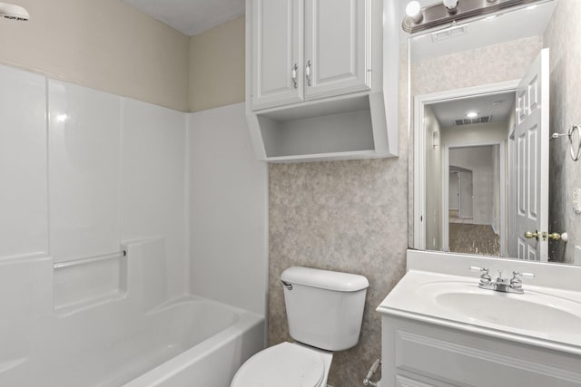 full bathroom featuring vanity, shower / washtub combination, and toilet