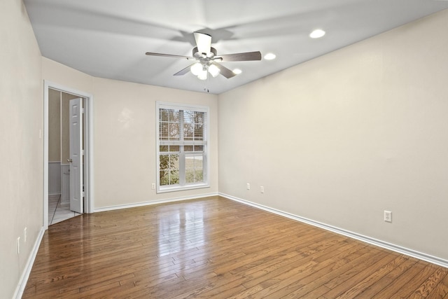 spare room with wood-type flooring and ceiling fan