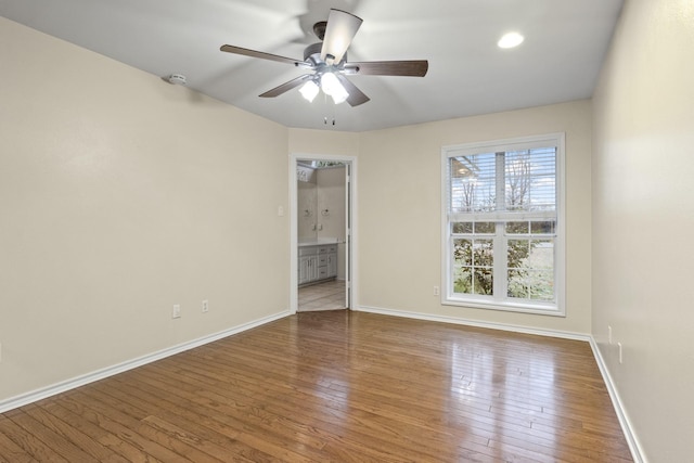 unfurnished room featuring ceiling fan and hardwood / wood-style floors