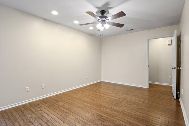 empty room with hardwood / wood-style flooring and ceiling fan