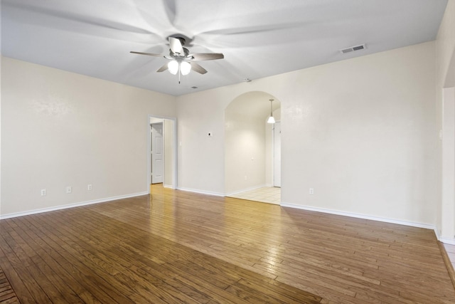 empty room featuring hardwood / wood-style floors and ceiling fan