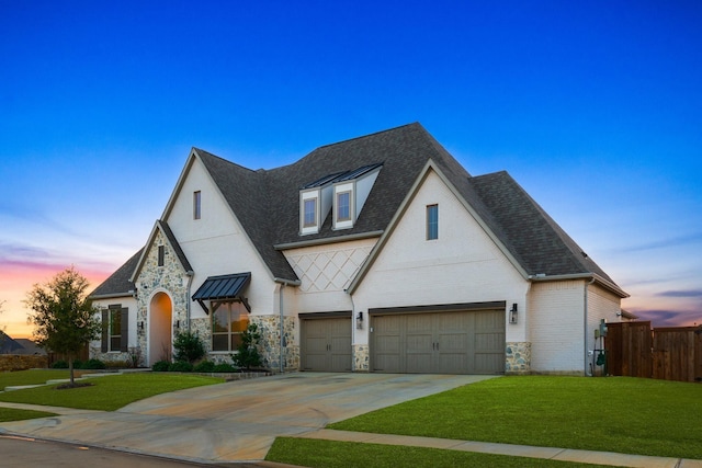 view of front of house with a garage and a yard