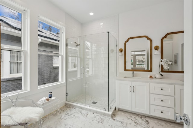 bathroom featuring vanity and a shower with shower door