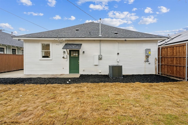 back of house featuring a patio, a yard, and central AC