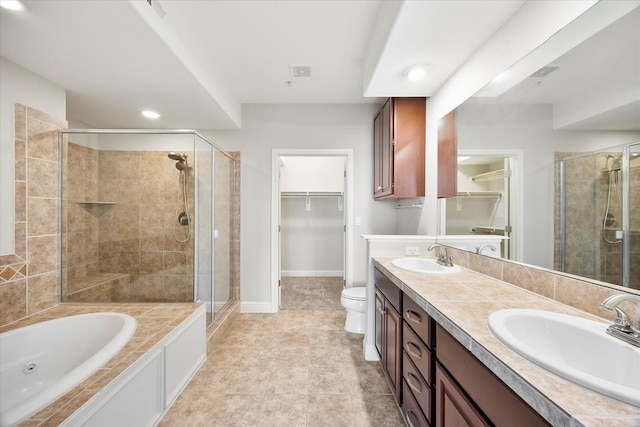 full bathroom featuring tile patterned flooring, vanity, separate shower and tub, and toilet