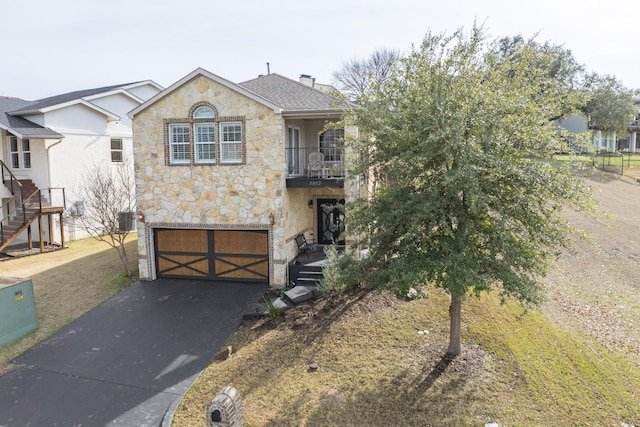 view of front of property featuring central AC and a garage