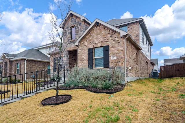 front of property featuring a front yard and central air condition unit