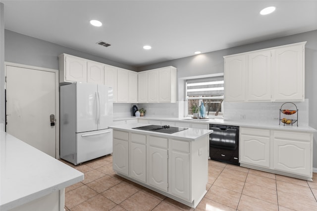 kitchen featuring a center island, light tile patterned floors, white cabinets, and black appliances