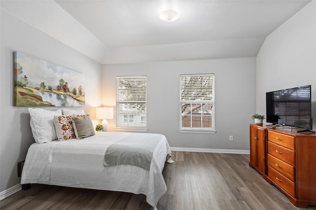 bedroom with lofted ceiling and hardwood / wood-style floors