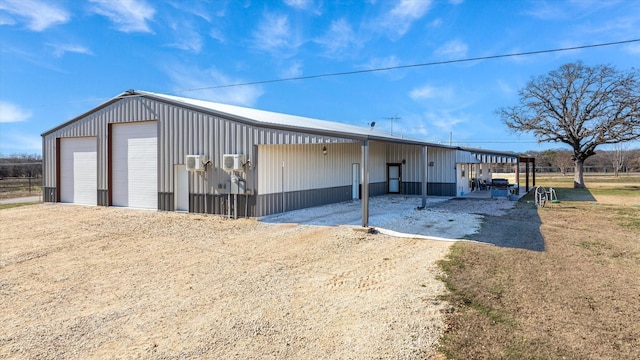 view of outdoor structure with a garage and a carport