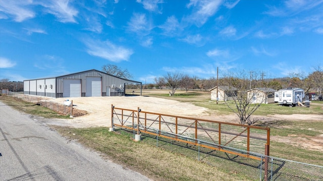 view of yard featuring a storage unit and a garage