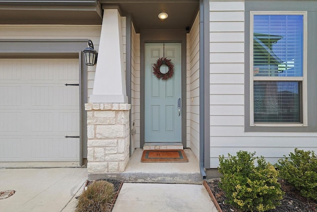 view of exterior entry with a garage