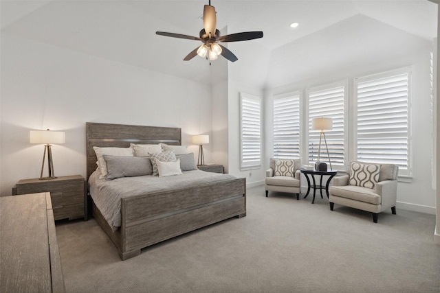 carpeted bedroom with ceiling fan, vaulted ceiling, and baseboards