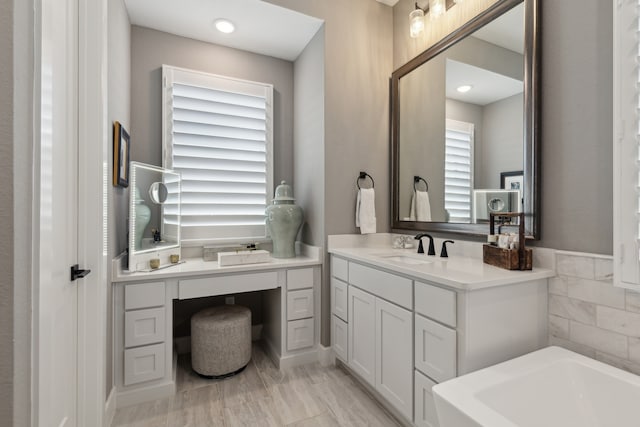 bathroom with vanity and a bathtub